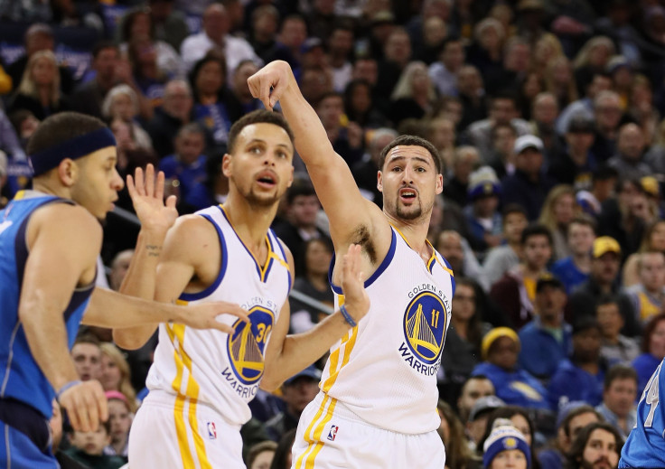 Stephen Curry Curry #30 and Klay Thompson #11 of the Golden State Warriors watch a shot go in taken by Thompson against the Dallas Mavericks at ORACLE Arena on Dec. 30, 2016 in Oakland, California.