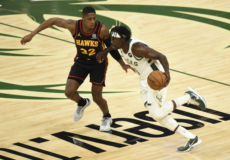 Jrue Holiday #21 of the Milwaukee Bucks drives against Kris Dunn #32 of the Atlanta Hawks