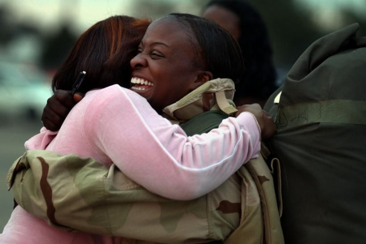 Army Sgt. Kimberly Singletary is hugged by family friend Regina Ayala during a welcome home ceremony at Hunter Army Airfield Dec. 30, 2005, in Savannah, Georgia.