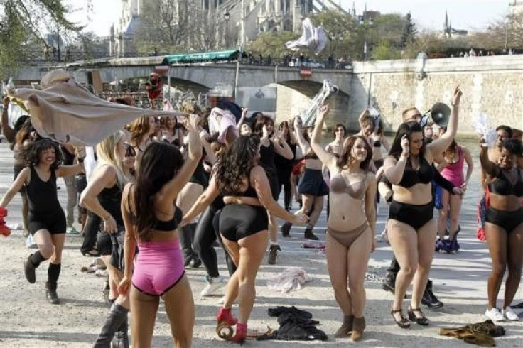 Women in their underwear dance during a flash-mob named &quot;beautiful naked&quot; organized by French TV M6 in front the Notre Dame Cathedral near the Seine river in Paris 