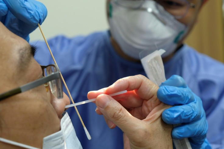 A doctor teaches volunteer medical staff how to collect a swab sample for Covid-19 testing in Hsinchu, Taiwan