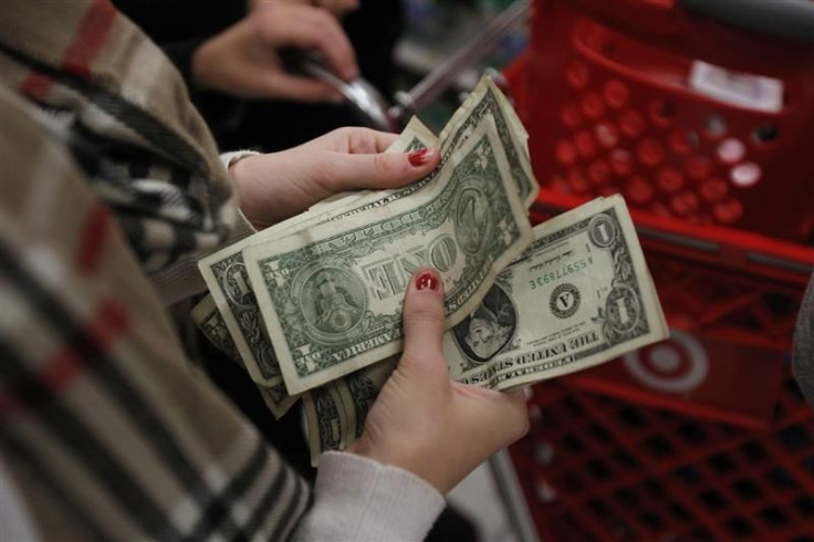 A customer counts her money while waiting in line to check out at a Target store on the shopping day dubbed "Black Friday," in Torrington, Connecticut November 25, 2011.