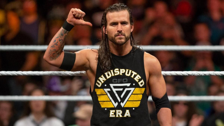 Adam Cole does his signature pose before entering the ring for a match.