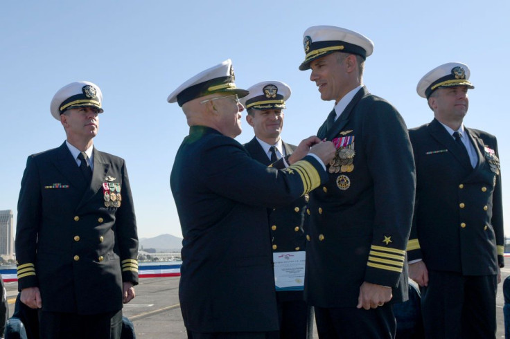 SAN DIEGO, CA - NOVEMBER 1, 2019: In this handout released by the U.S. Navy, Vice Adm. DeWolfe Miller, center-left, commander of Naval Air Forces, awards Capt. Carlos Sardiello, commanding officer of the aircraft carrier USS Theodore Roosevelt (CVN 71), w