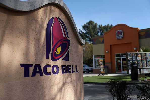 Taco Bell has launched new holiday collection of sweaters, onesies, T-shirts, and more. A sign is posted in front of a Taco Bell restaurant on February 22, 2018 in Novato, California. Taco Bell has become the fourth-largest domestic restaurant brand by ed