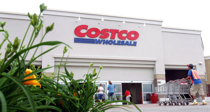 A worker pushes carts outside a Costco Wholesale store on May 31, 2006, in Mount Prospect, Illinois.