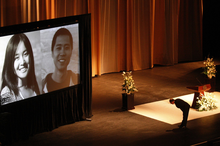 USC (University of Southern California) president C. L. Max Nikias bows before images of Chinese murder victims Ying Wu and Ming Qu before eulogizing the slain engineering students during a memorial service in the Shrine Auditorium in Los Angeles on Apr.