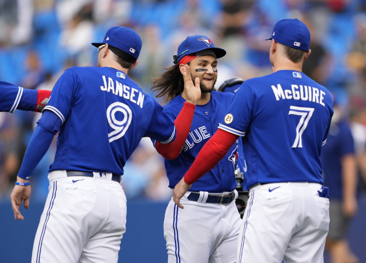 Bo Bichette #11, Reese McGuire #7, and Danny Jansen #9 of the Toronto Blue Jays celebrate defeating the Tampa Bay Rays during their MLB game at the Rogers Centre on September 15, 2021 in Toronto, Ontario, Canada. 