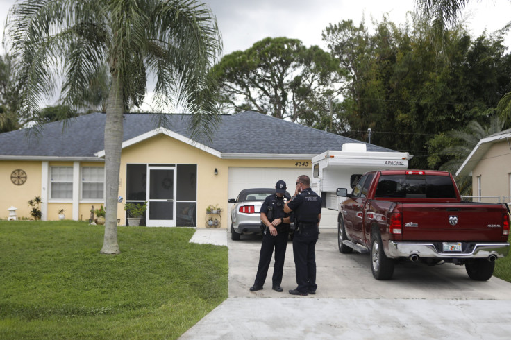 North Port Police officers stands in the driveway of Brian Laundrie, who is a person of interest after his fiancé Gabby Petito went missing on Sept. 20, 2021 in North Port, Florida.