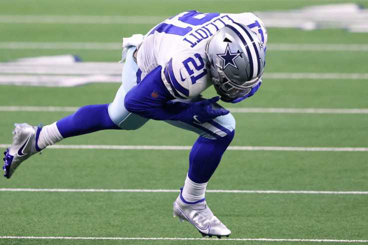 Ezekiel Elliott #21 of the Dallas Cowboys runs against the Arizona Cardinals during the second quarter at AT&T Stadium on October 19, 2020, in Arlington, Texas.