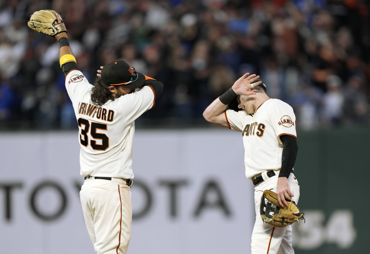 Brandon Crawford #35 and Mike Yastrzemski #5 of the San Francisco Giants celebrates defeating the Los Angeles Dodgers 6-4 at Oracle Park on September 05, 2021 in San Francisco, California.