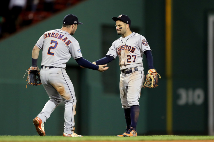 Alex Bregman #2 and Jose Altuve #27 of the Houston Astros celebrate their team's win over the Boston Red Sox in Game One of the American League Championship Series at Fenway Park on October 13, 2018 in Boston, Massachusetts.