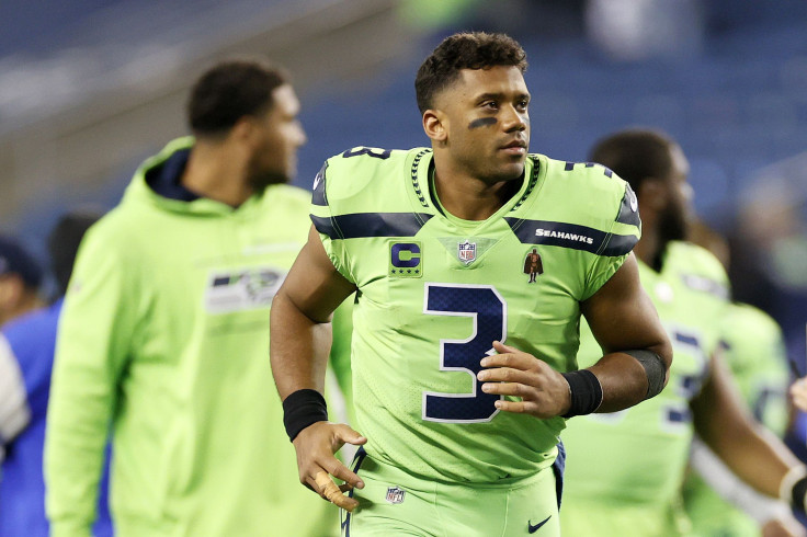 Russell Wilson #3 of the Seattle Seahawks jogs off the field while tending to his finger injury after losing 26-17 to the Los Angeles Rams at Lumen Field on October 07, 2021 in Seattle, Washington. 