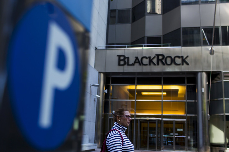 A woman walks next to a BlackRock sign pictured in the Manhattan borough of New York, Oct. 11, 2015.
