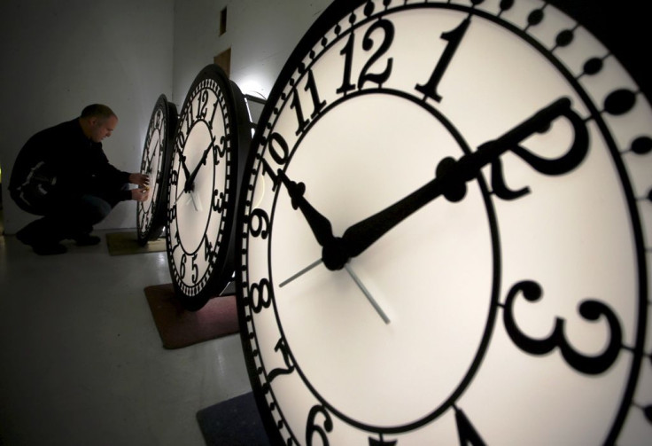 A man checks one of four custom, flush mounted clocks, destined for installation in Kansas City, Missouri, at the Electric Time Company factory in Medfield, Massachusetts, March 8, 2013.