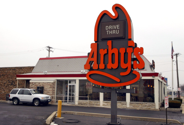 Arby's bought Buffalo Wild Wings in a transaction that's valued at $2.9 billion. An SUV is pictured sitting at the pick-up window of an Arby's restaurant December 13, 2002 in Des Plaines, Illinois.