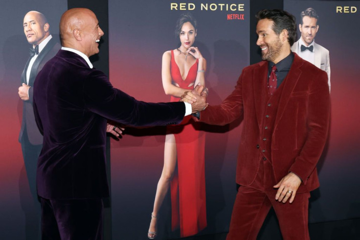 LOS ANGELES, CALIFORNIA - NOVEMBER 03: Dwayne Johnson greets Ryan Reynolds at the world premiere of Netflix's "Red Notice" at L.A. LIVE on November 03, 2021 in Los Angeles, California.