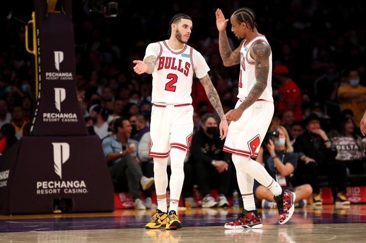 Lonzo Ball #2 and DeMar DeRozan #11 of the Chicago Bulls celebrate a shot made by Ball during the fourth quarter against the Los Angeles Lakers at Staples Center on November 15, 2021 in Los Angeles, California.