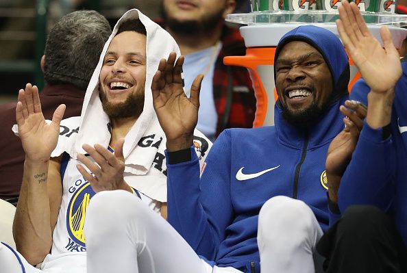 Kevin Durant (R) recently stated it's weird to play without the likes of Stephen Curry (L) and others.