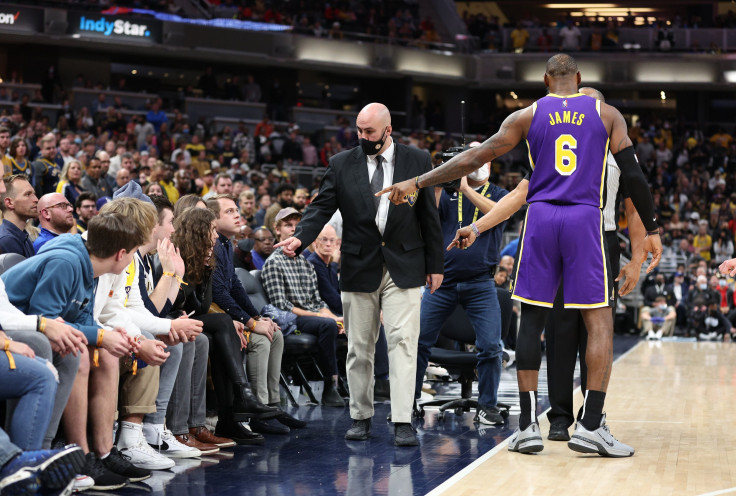 LeBron James #6 of the Los Angeles Lakers points out fans that he had a disturbance with to security during the game against the Indiana Pacers at Gainbridge Fieldhouse on November 24, 2021 in Indianapolis, Indiana.