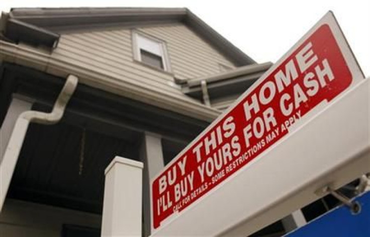 The sign on a property for sale in Somerville, Massachusetts reads &quot;Buy This Home I'll Buy Yours For Cash&quot; October 25, 2010.