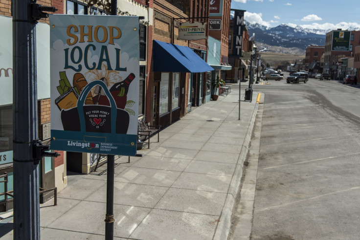 A sign reading "Buy Local" with closed restaurants and shops on Main Street on April 10, 2020 in Livingston, Montana.