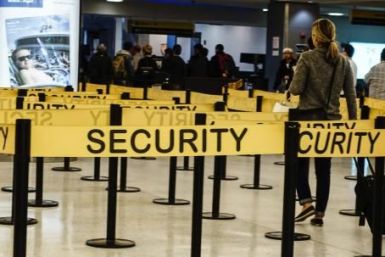 Passengers make their way in a security checkpoint at the International JFK airport in New York on Oct. 11, 2014.