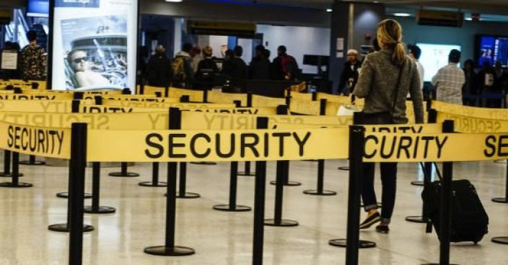 Passengers make their way in a security checkpoint at the International JFK airport in New York on Oct. 11, 2014.