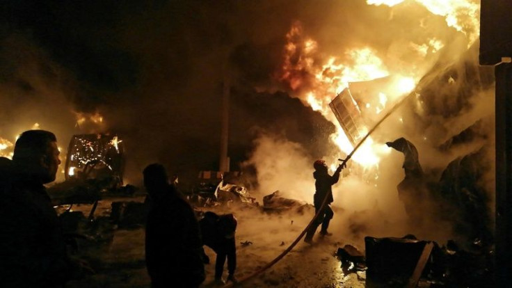 A firefighter battles a blaze in Syria's Latakia port after it is hit by an Israeli air strike for only the second time in the decade-old civil war