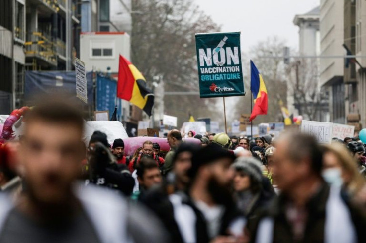 A person holds a sign reading "No to mandatory vaccination" during a demonstration against COVID-19 vaccination in Europe