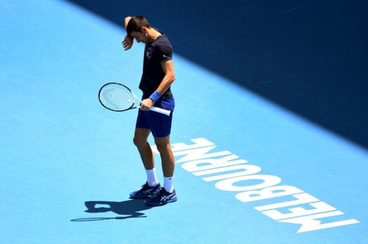 Novak Djokovic of Serbia wipes the sweat from his brow during a practice session ahead of the Australian Open at the Melbourne Park tennis centre