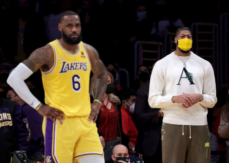 Anthony Davis #3 of the Los Angeles Lakers watches with LeBron James #6