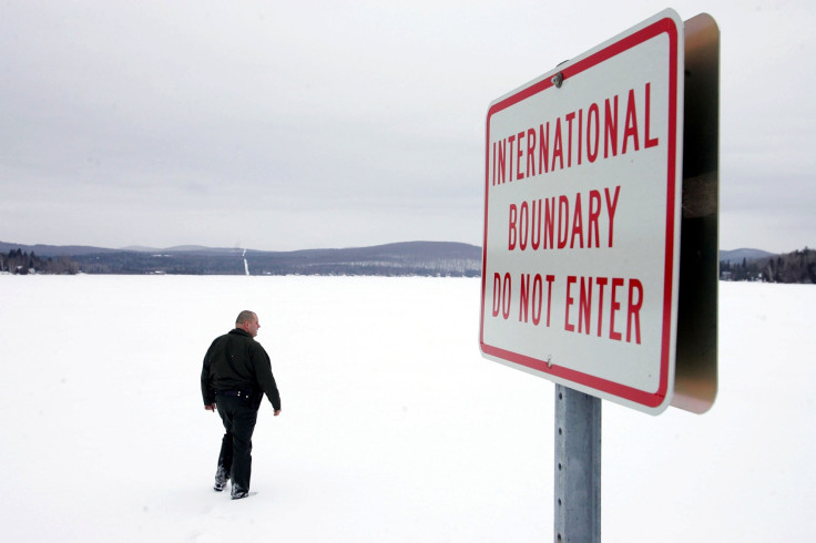 NORTON, VT - MARCH 22: U.S. Border Patrol Agent Andrew Mayer walks onto a frozen lake during a patrol on the lake that is split between Canadian territory to the right and the U.S. March 22, 2006 near Norton, Vermont.