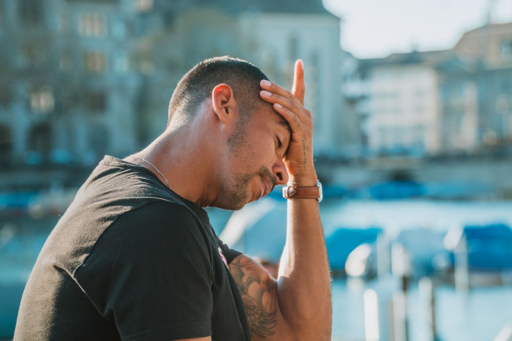 Representation. A man experiencing a headache.
