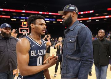 Bronny James #0 of the Sierra Canyon Trailblazers is greeted by his father and NBA player LeBron James