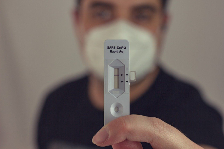 Pictured: Representative image of an individual holding a SARS-CoV-2 rapid test.