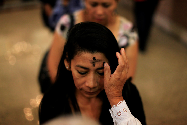 A Catholic faithful has her forehead marked with ash during a mass for Ash Wednesday at the San Salvador Cathedral in San Salvador, El Salvador, March 1, 2017.