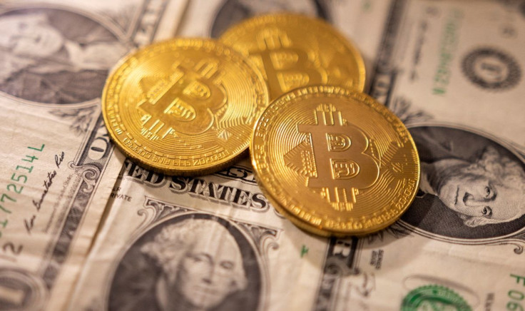 A representations of cryptocurrency Bitcoin placed on U.S. dollars in this illustration taken, January 24, 2022.