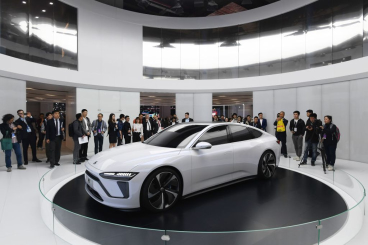 Visitors look at a Nio ET Preview car at the Shanghai Auto Show in Shanghai on April 16, 2019.