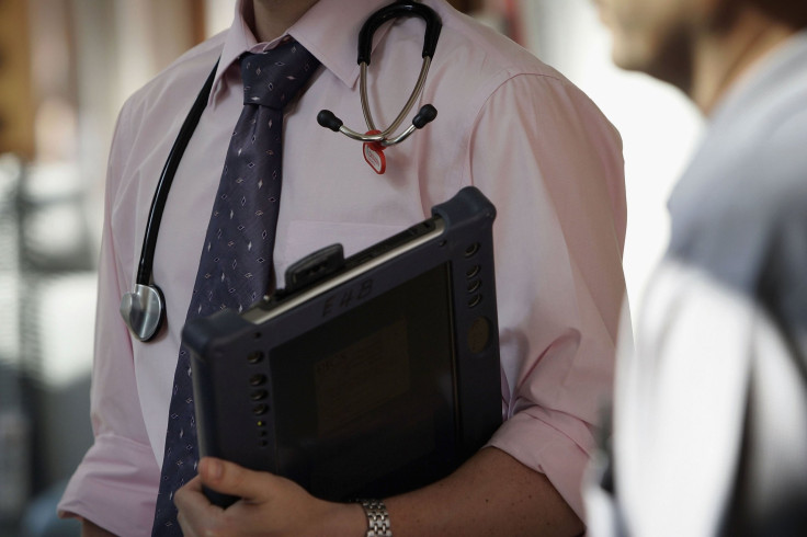 A doctor at the Queen Elizabeth Hospital Birmingham does his rounds on the wards in 2006. Wednesday is National Doctors' Day.