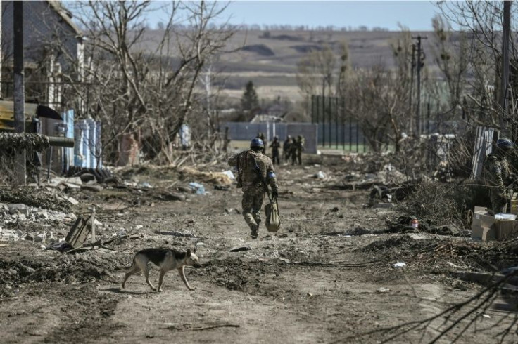 A Ukranian serviceman walks in the village of Mala Rogan, east of Kharkiv, after Ukrainian troops retook the village