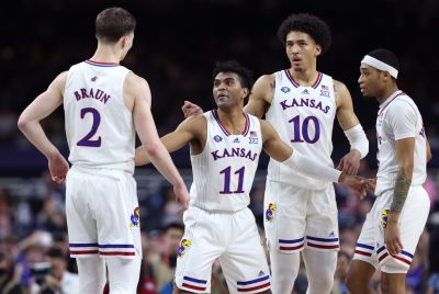 L-R Christian Braun #2, Remy Martin #11, Jalen Wilson #10 and Dajuan Harris Jr. #3 of the Kansas Jayhawks react in the second half of the game against the Villanova Wildcats during the 2022 NCAA Men's Basketball Tournament Final Four semifinal at Caesars