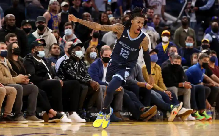 Ja Morant of the Memphis Grizzlies celebrates they beat the Golden State Warriors in overtime at Chase Center on October 28, 2021
