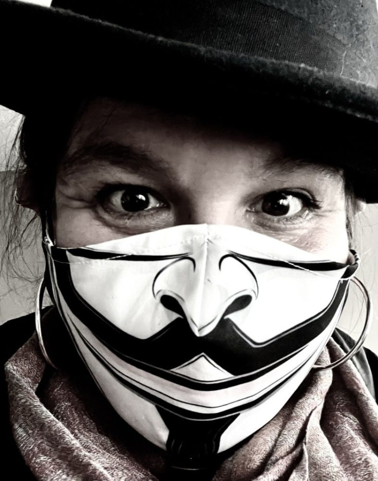 Dr. Patsy Evans wearing a Guy Fawkes facemask