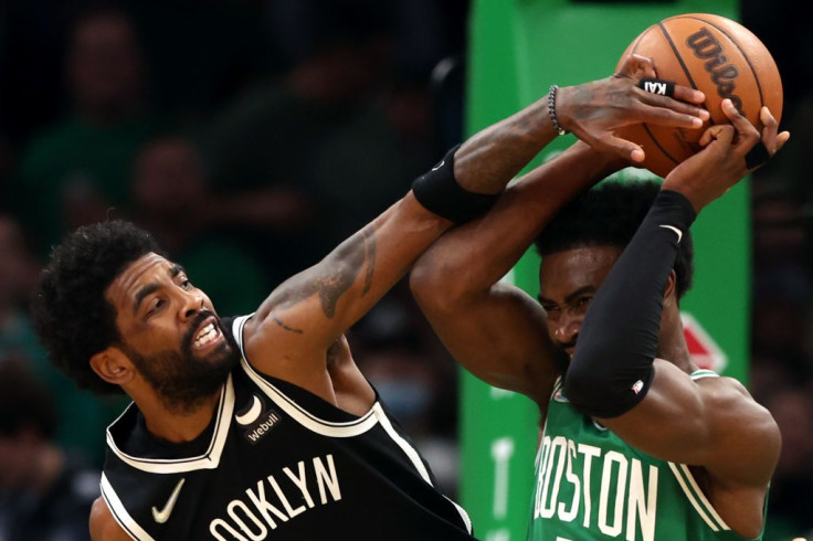 Kyrie Irving #11 of the Brooklyn Nets defends a shot from Jaylen Brown #7 of the Boston Celtics