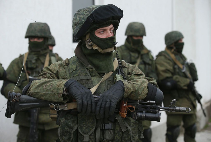 Soldiers who were among several hundred that took up positions around a Ukrainian military base stand near the base's periphery in Crimea on March 2, 2014 in Perevalne, Ukraine. Several hundred heavily-armed soldiers not displaying any idenifying insignia