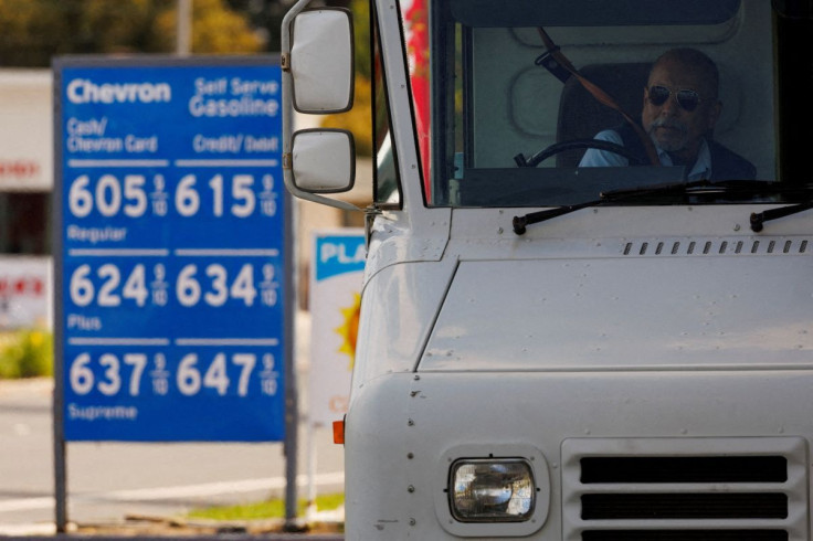 A U.S. postal worker puts his seatbelt on after filing up his vehicle  at a gas station in Garden Grove, California, U.S., March 29, 2022.  