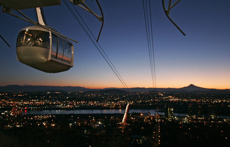 One of the two cars in the new aerial tram rises above Portland, Oregon at sunrise on Jan. 31, 2007.