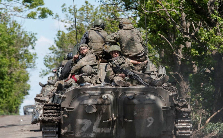 Service members of pro-Russian troops are seen atop an armoured vehicle on a road in the course of Ukraine-Russia conflict near Mariupol in the Donetsk region, Ukraine May 20, 2022. 