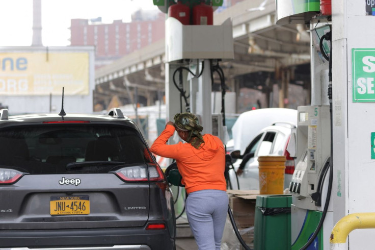 A person uses a petrol pump at a gas station as fuel prices surged in Manhattan, New York City, U.S., March 7, 2022.